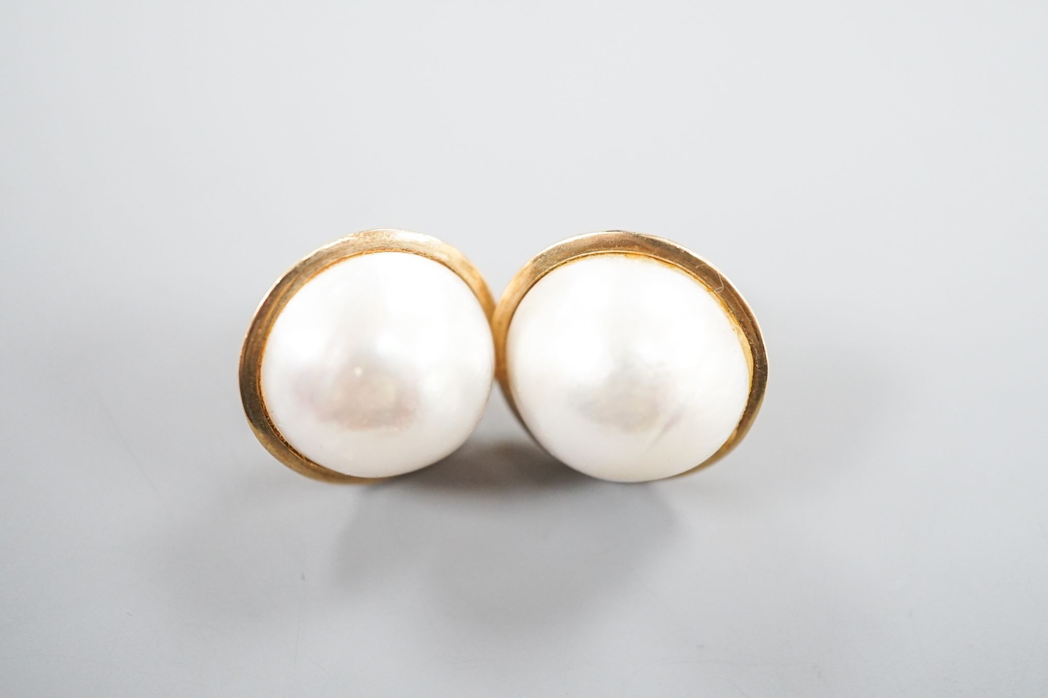 A pair of yellow metal and mabe pearl earrings, 2mm, gross weight 13.3 grams.